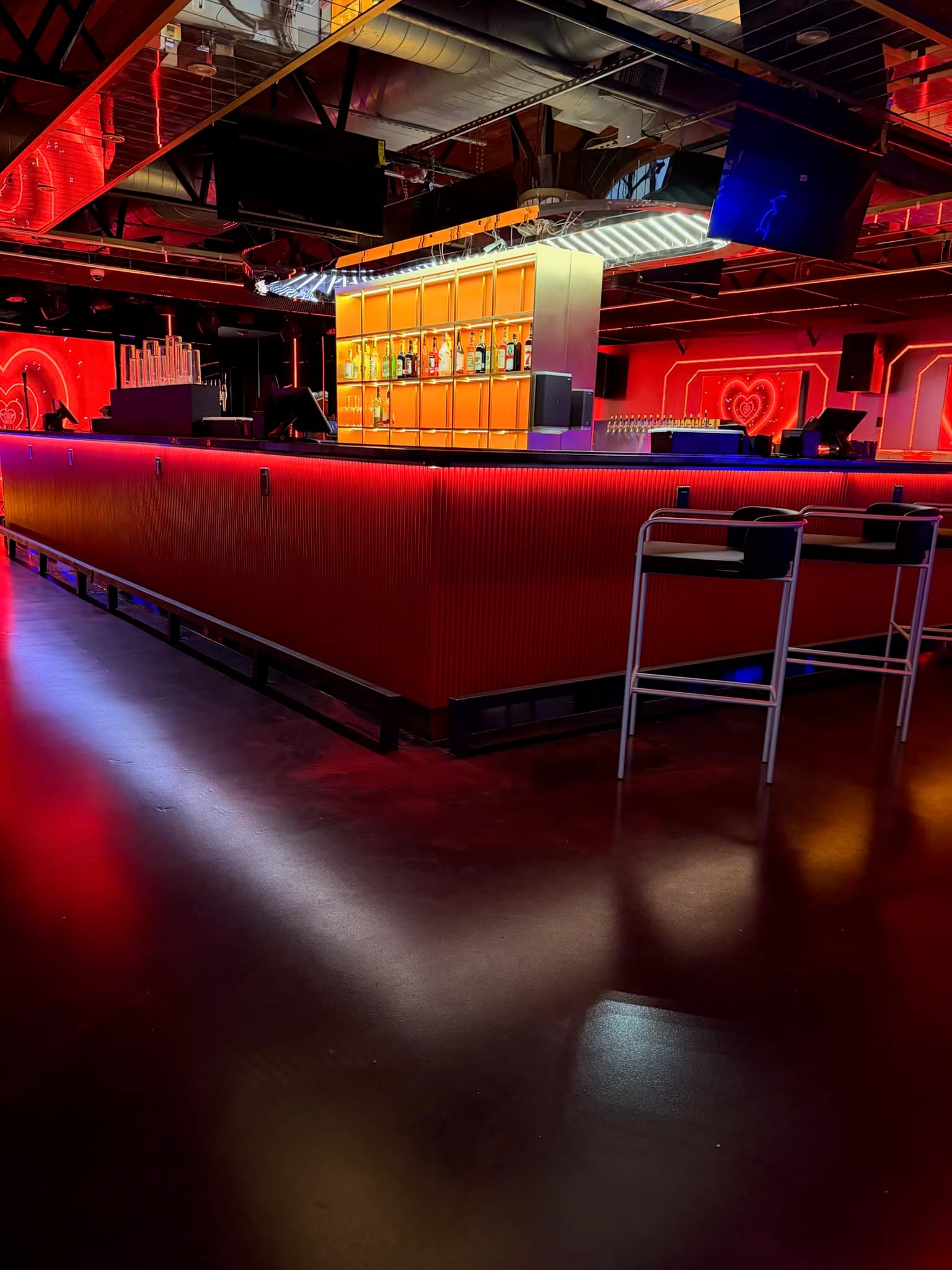 The red illuminated bar inside 69 Lounge in Houston